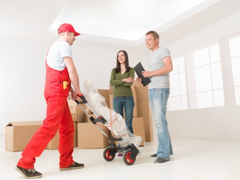 Professional movers handling furniture during a Deptford home move